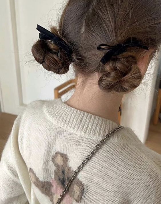 cute low buns of braids accented with black velvet bows are a lovely hairstyle you can rock anytime