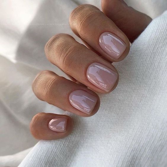 glossy mauve nails of a square shape are a cool take on classic nudes, they offer a subtle touch of color