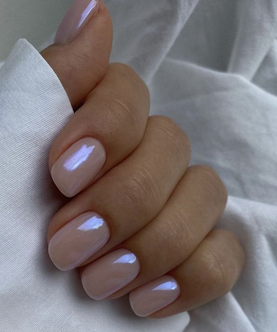 iridiscent nude nails of a square shape are a fresh take on nudes, it’s a more modern take on them