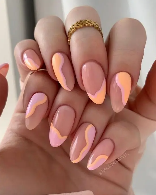 Lovely and catchy almond shaped nails with a touch of pink and Peach Fuzz done with an abstract design