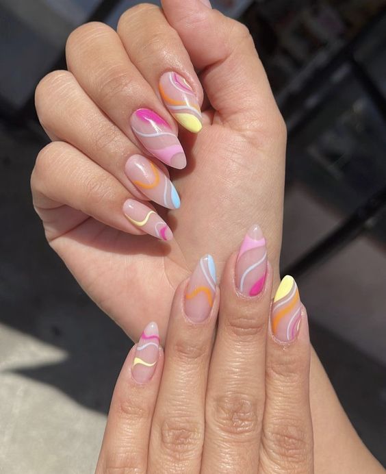 Super colorful almond shaped swirl nails in pink, hot pink, yellow, blue are adorable for spring and summer