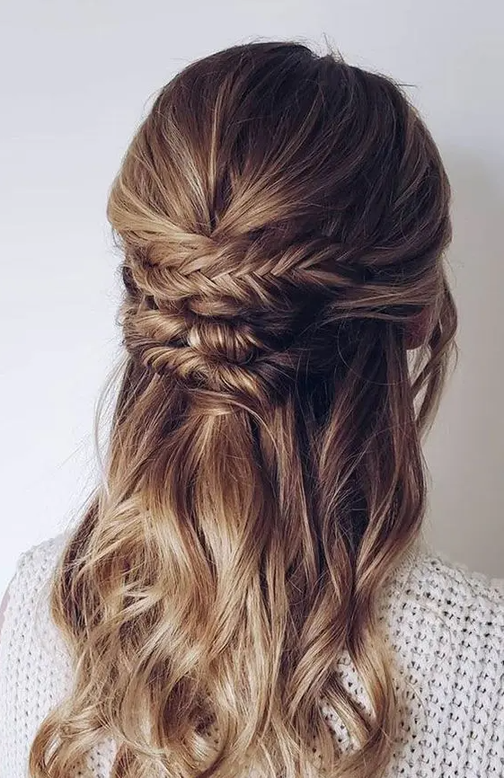 a beautiful boho half updo with a textured top and a braided and twisted element plus waves down is a cool idea
