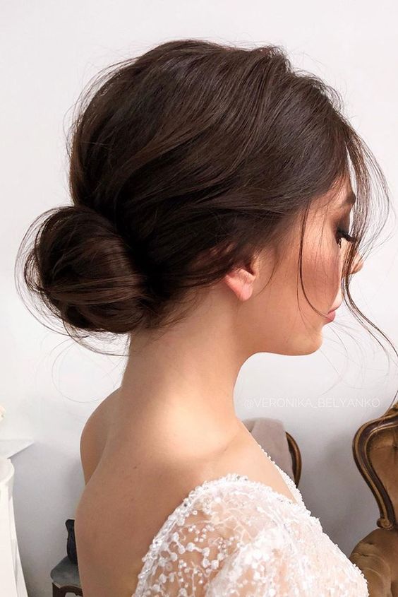 a beautiful low bun with a bump on top, some hair down is a chic and stylish hairstyle for a wedding