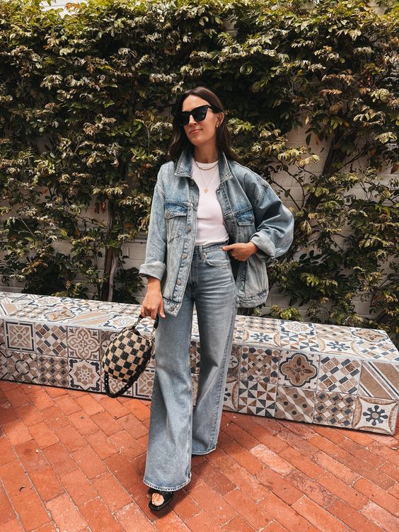 a bleached oversized denim jacket, flare jeans, black sandals and a checked bag for spring
