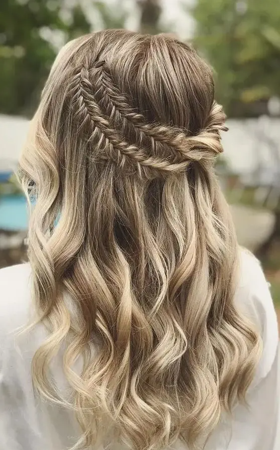 a boho half updo with a double fishtail braid halo and waves down is a dreamy and beautiful idea