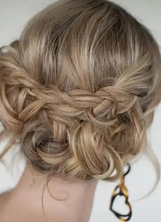 a boho updo with braids and twists and some waves down plus a bump on top is a stylish and cool idea