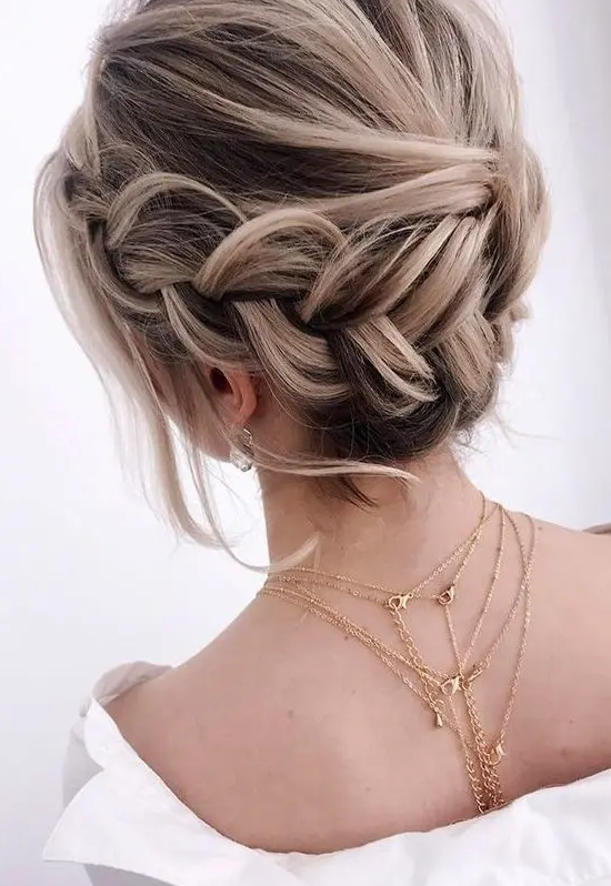 a braided halo low updo with a volume on top, some waves down is a lovely idea for a boho look at the wedding