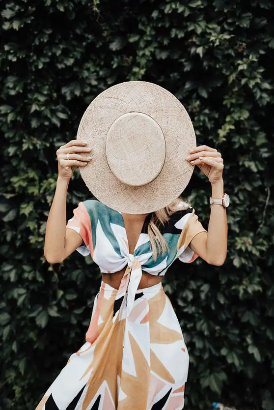 a breezy and light two piece summer dress with a tied crop top with short sleeves and a midi skirt, a hat