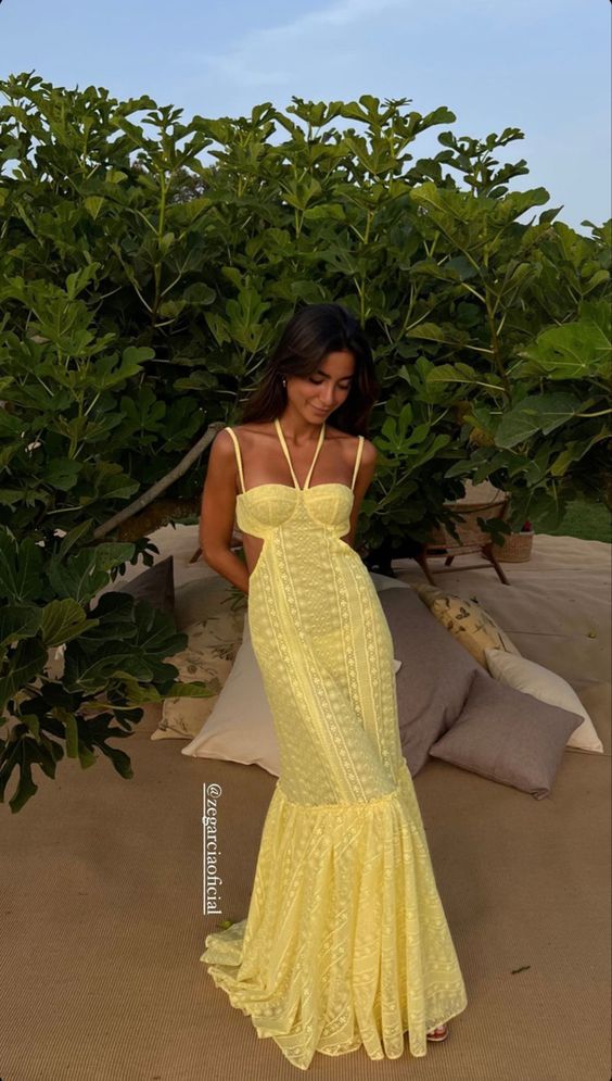 a bright yellow mermaid dress with cutout sides and spaghetti straps is a super bold and sexy solution for a wedding