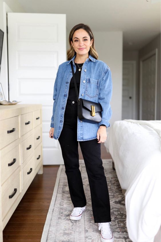a casual spring look with a black tee, black jeans, a blue denim shirt, white sneakers and a black bag is comfy