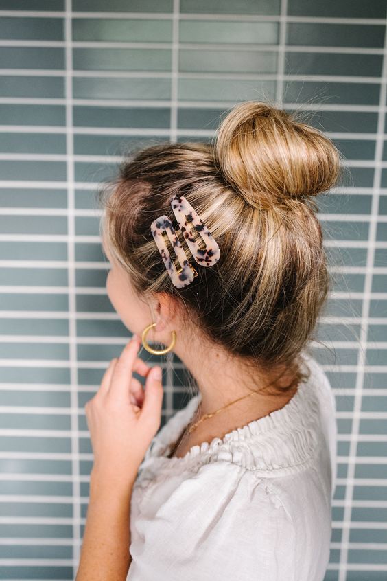 a casual top knot with a volumetric top and some snap hairpins is a cool idea for medium and long hair