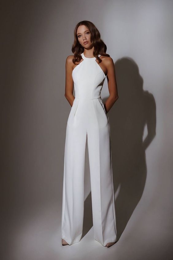 a chic and refined white halter neck jumpsuit is a cool and bold alternative to a usual white dress