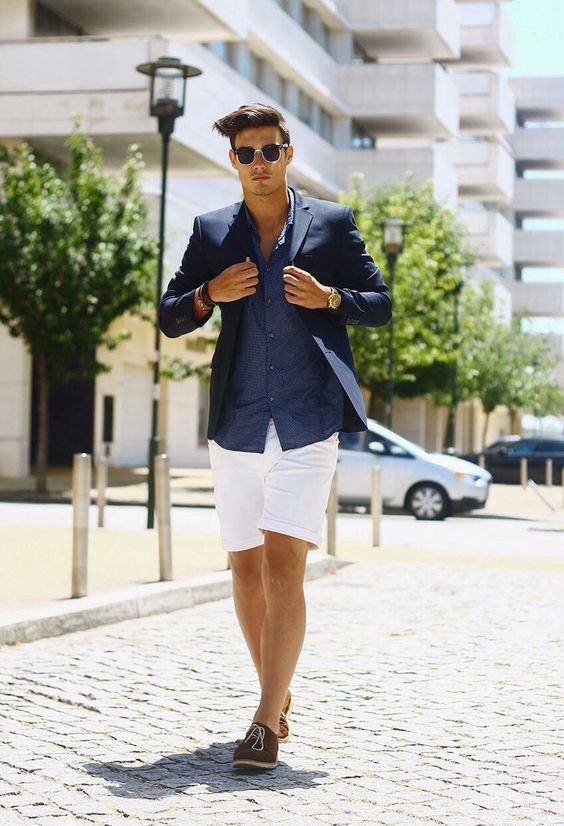a chic beach wedding guest look with a navy linen shirt and blazer, white linen shorts, brown moccasins