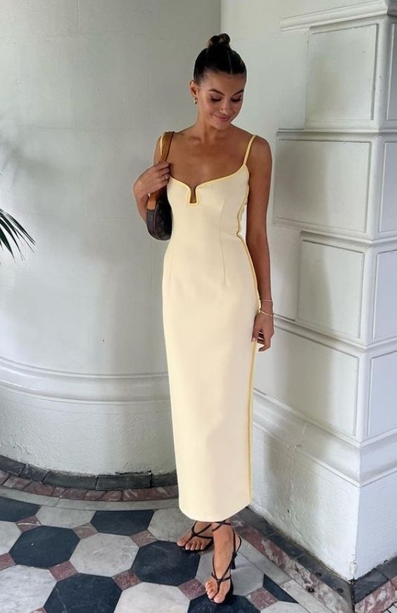 a cool ivory maxi dress with a deep neckline and spaghetti straps, black strappy shoes and a small baguette bag