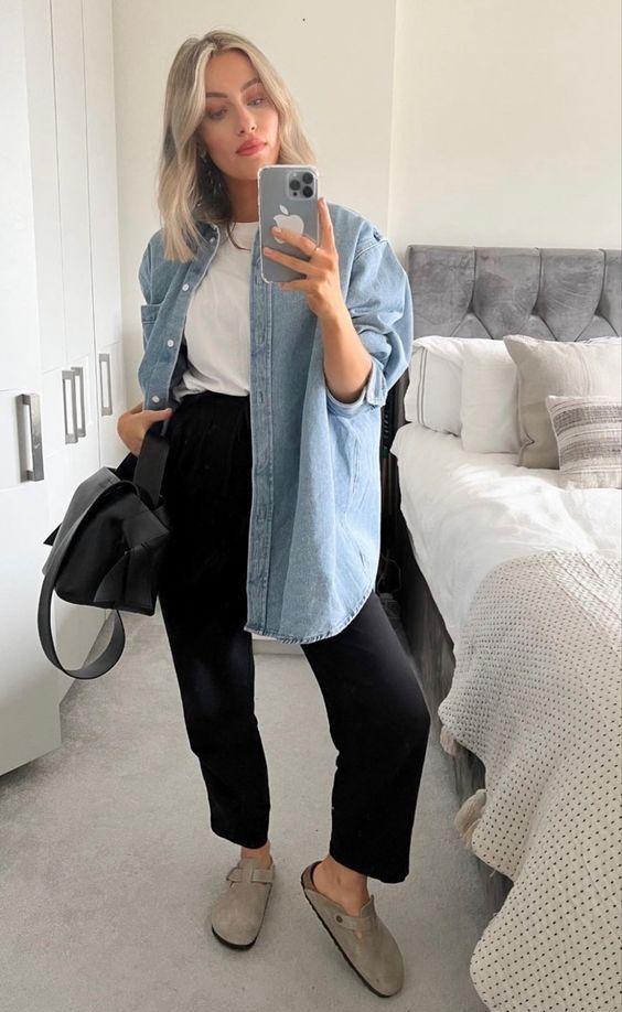 a cool spring look with a white t-shirt, black trousers, grey slipper mules and a black bag plus a blue denim oversized shirt