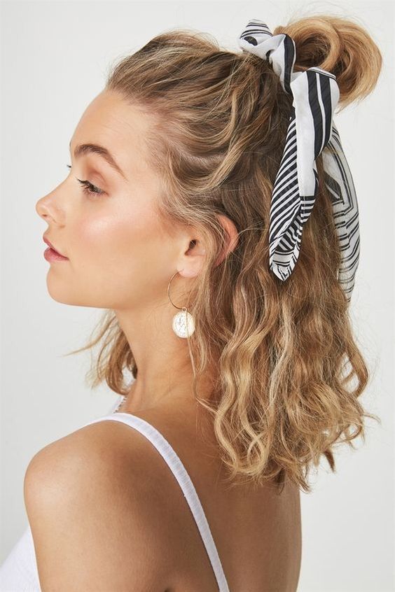 a lovely half updo with a top knot accented with a hair scarf and waves down is a stylish idea for every day