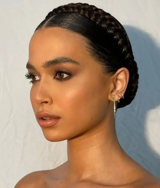 a lovely updo with a small braided halo and a sleek top will do for medium to long and long hair