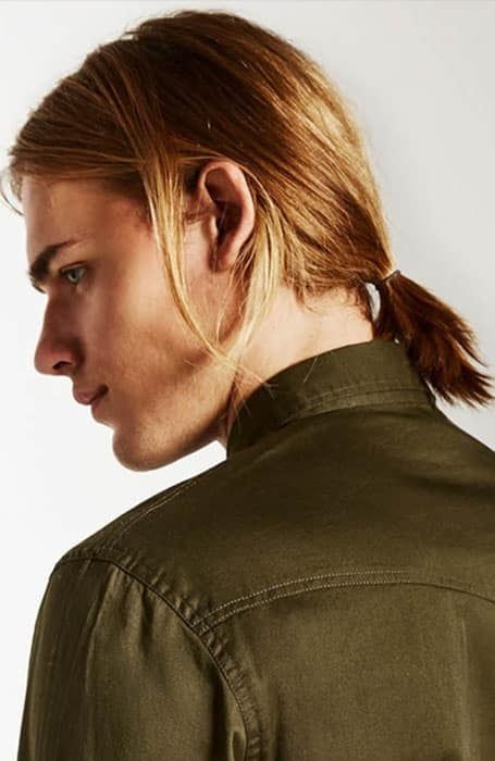 a man bob styled with a small low ponytail is a cool way to keep the hair off the face