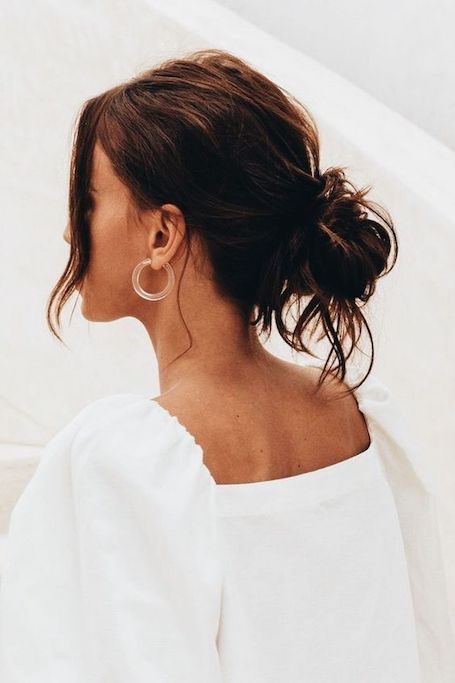 a messy low bun with a messy top and face-framing hair is a cool hairstyle for every day