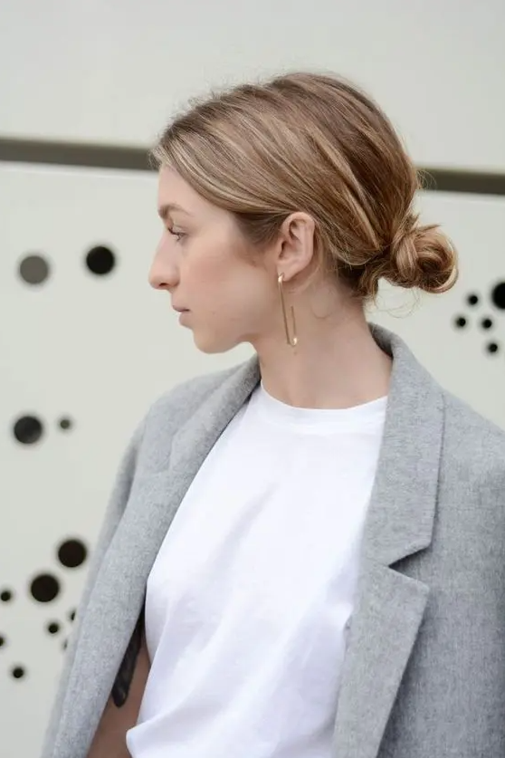 a messy low bun with a textured volume on top is a fast and cool idea for a modern or casual wedding