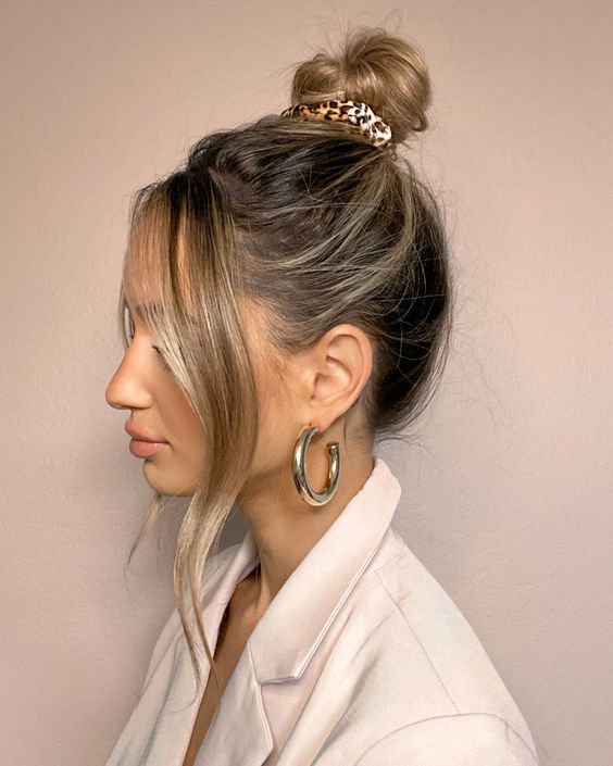 a messy top knot and face-framing waves are a cool solution for every day, it's easy to make