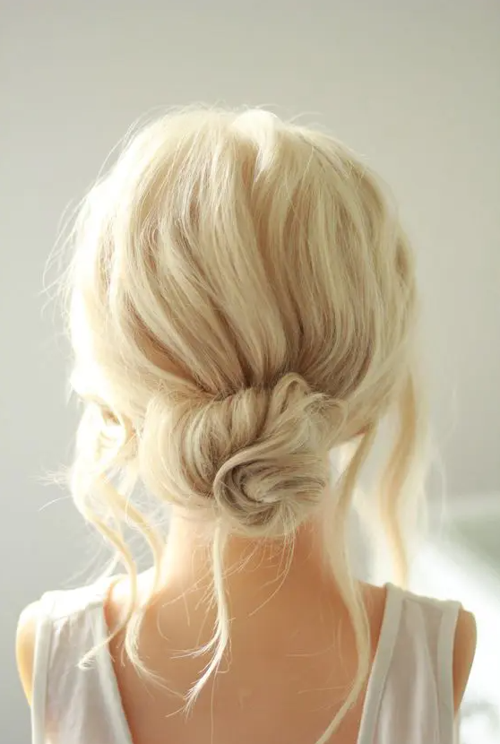 a messy twised low bun with a messy bump on top and some locks down is a chic and cool idea if your style isn’t too formal