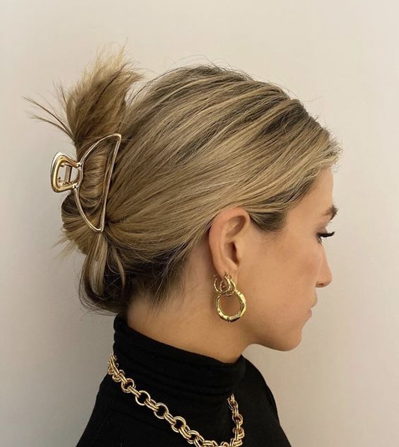 a messy updo secured with a hair piece, with a messy top is a cool idea for every day, you can do that on the go