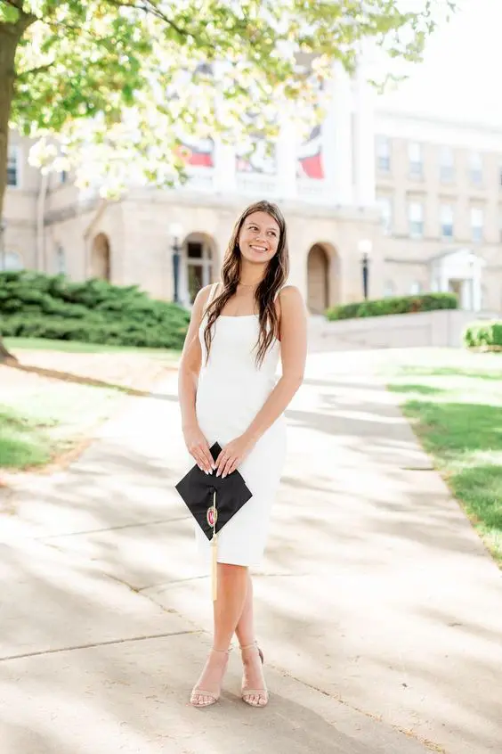 a midi white dress with straps, nude shoes and a necklace are a perfect combo for graduation that always works