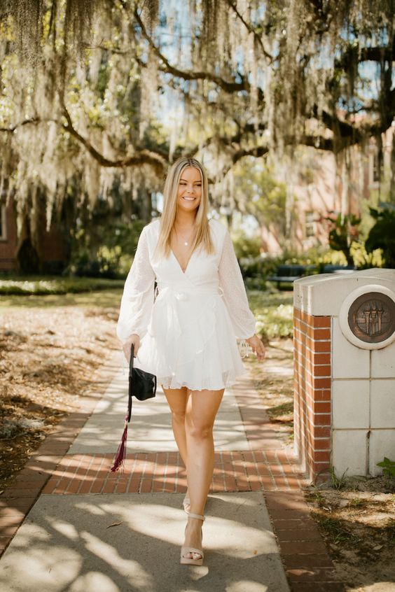 A mini wrap A line dress with long sleeves, a black bag and nude shoes are a timeless combo for graduation