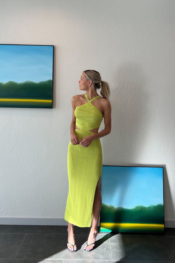 a neon green maxi dress with a halter neckline, side cutouts, a side slit and black heels for a beach wedding