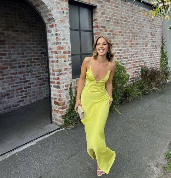 a neon yellow maxi dress with spaghetti straps, white shoes and a small bag are a cool combo for a beach wedding