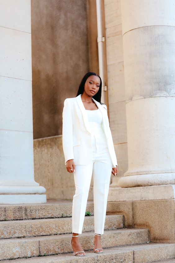 a refined white look with a pantsuit, a top and minimal shoes is a super cool outfit for graduation and for work, too