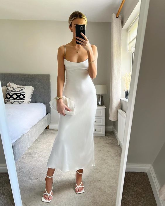 a refined white slip maxi dress with lace up shoes and a small bag plus some jewelry are a chic and catchy outfit for graduation