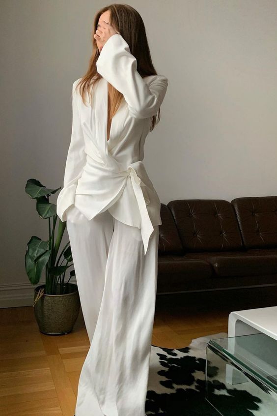 a relaxed white pantsuit with a wrap blazer and wideleg pants is a super cool alternative to a usual white dress
