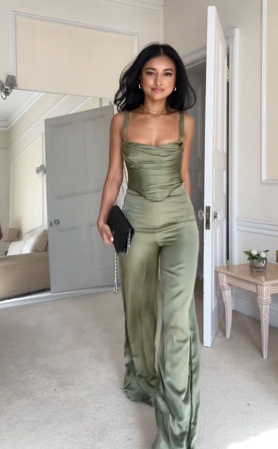 a sage satin suit with a draped corset top and matching pants, a necklace and a clutch are amazing for a bold and sexy graduation look