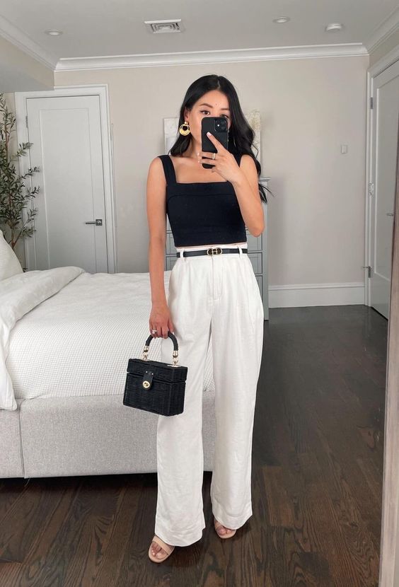 a simple and cool graduation look with a black top with a square neck, white pants, a black belt, nude shoes and a small black bag