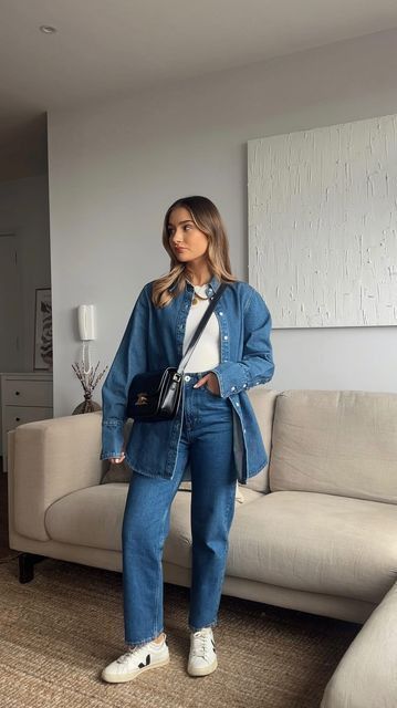a simple and quick denim outfit with an oversized shirt, jeans, a white top and white sneakers plus a black bag