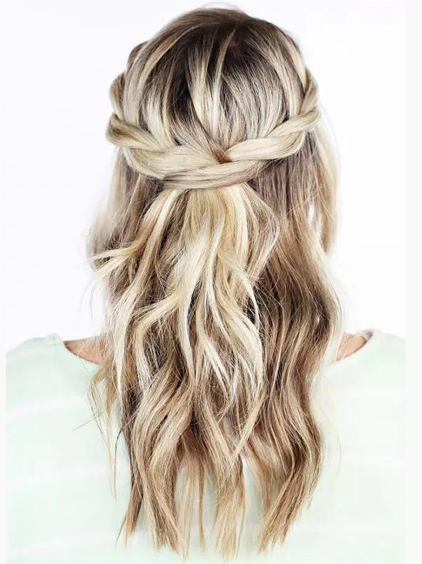 a simple boho or rustic wedding half updo with a braided halo, waves down is a cool idea for relaxed bridal styles