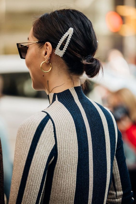 a simple small low bun with a sleek top accented with a pearl hair piece is a cool idea for every day, and you may change the accessory