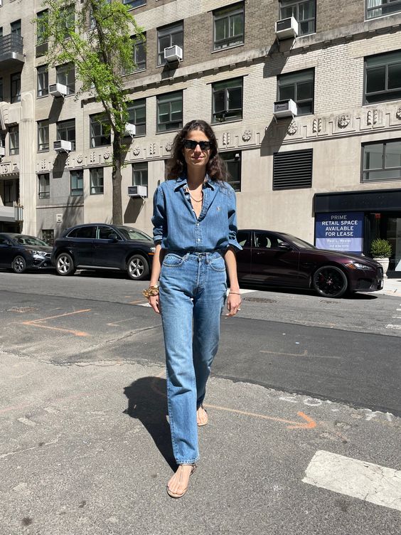 a simple spring look with a blue denim shirt, jeans, simple sandals and some gold jewelry is wow