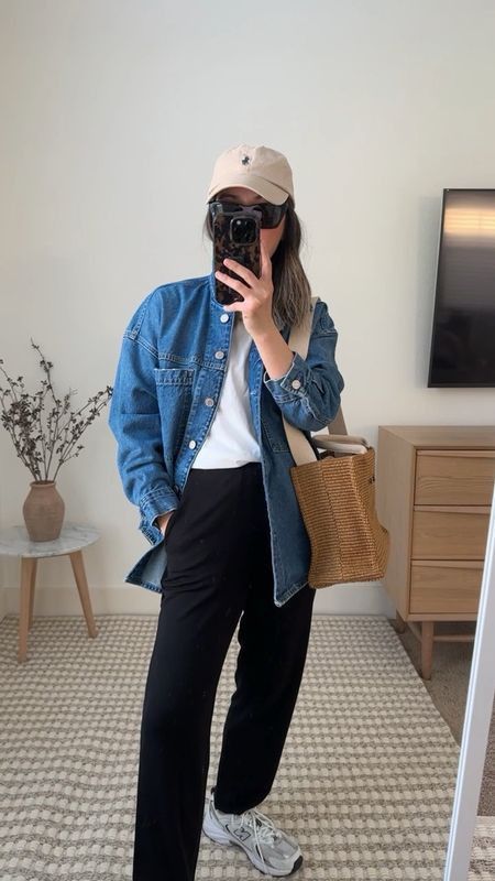 a sport chic look with a white tee, black pants, grey trainers, a blue denim jacket, a tote and a tan cap