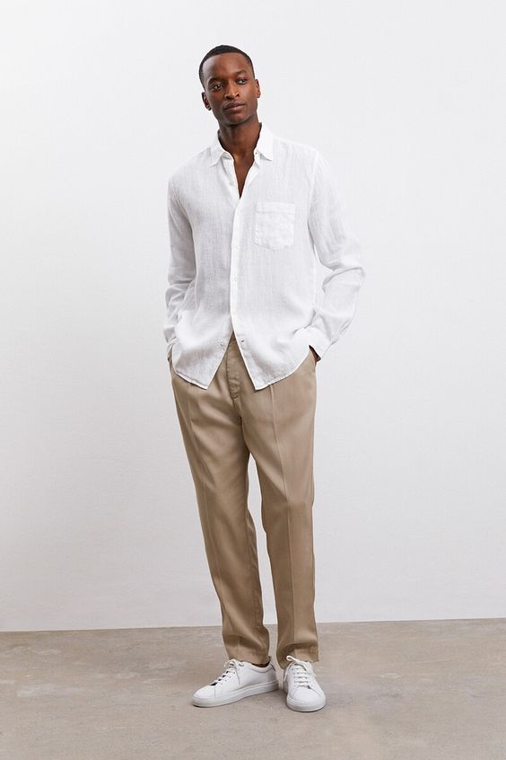 a timeless beach wedding guest look with a white linen button down, beige pants, white sneakers will always work