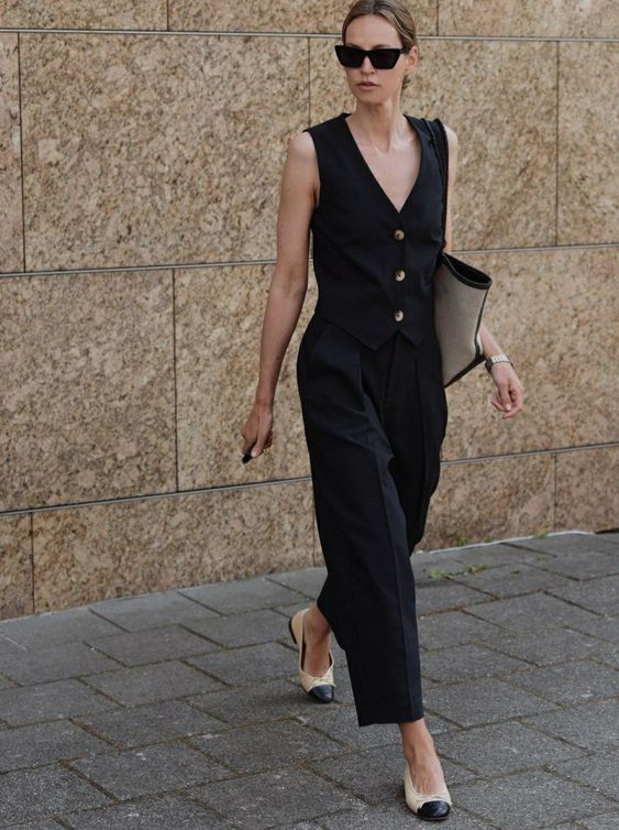 A trendy black look with a vest and pants, two tone shoes and a tote is a cool idea for graduation and for work, too