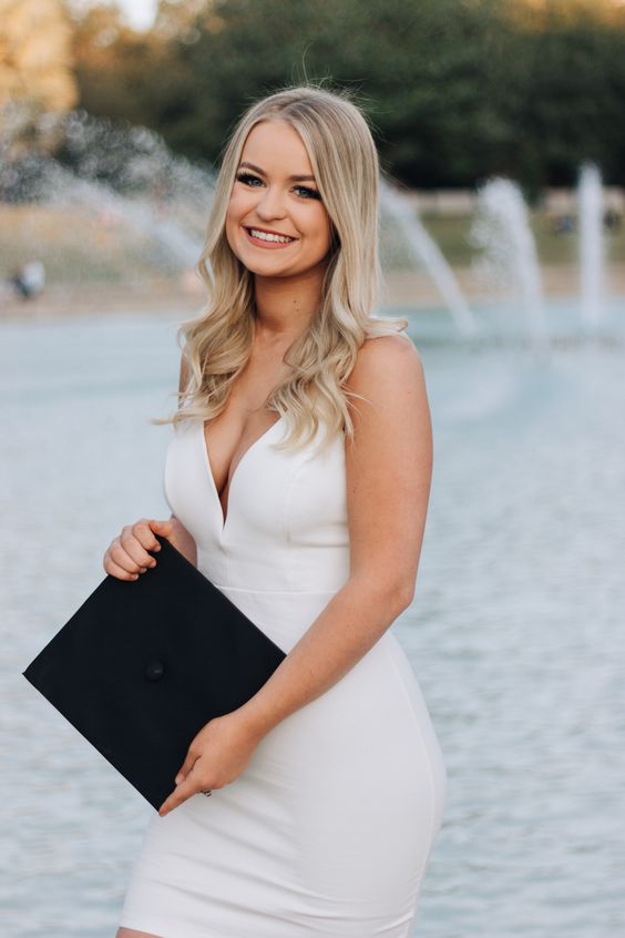 a white bodycon mini dress with a deep neckline and straps is a gorgeous and sexy look for graduation