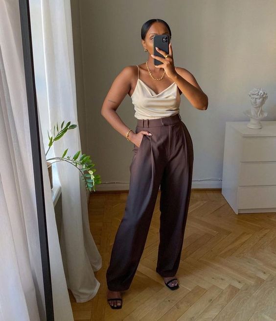 a white cami top, aubergine straight pants, black minimalist heels and a chic necklace are a lovely look for a wedding guest