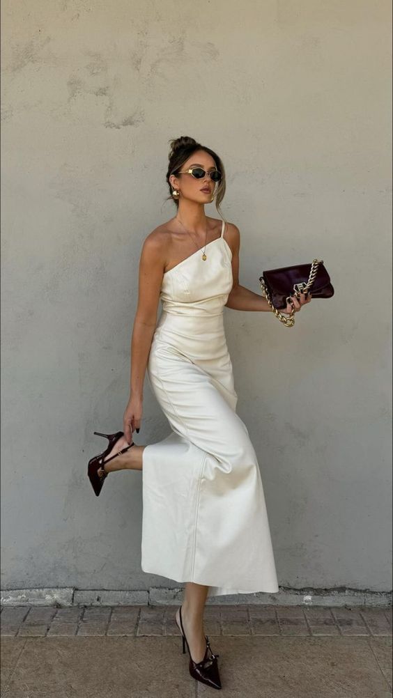 a white one shoulder midi dress, black slingbacks, a black bag and chic gold jewelry are a cool and chic outfit