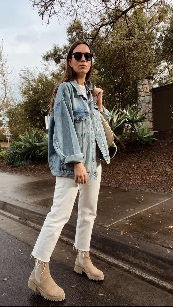 a white t-shirt, white jeans, a bleached denim jacket, tan Chelsea boots and a straw bag