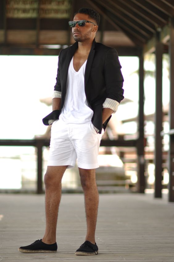 a white top, shorts, a black blazer, black espadrilles are a cool combo for a beach wedding