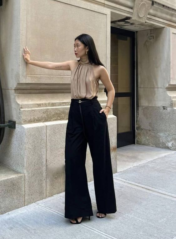 an elegant outfit with a beige draped halter neck top, black velvet palazzo pants and black shoes is a super chic look for graduation