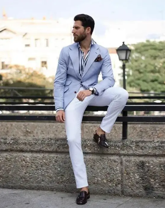 an elegant striped shirt, white trousers, a light blue blazer, brown shoes and a handkerchief are a lovely look